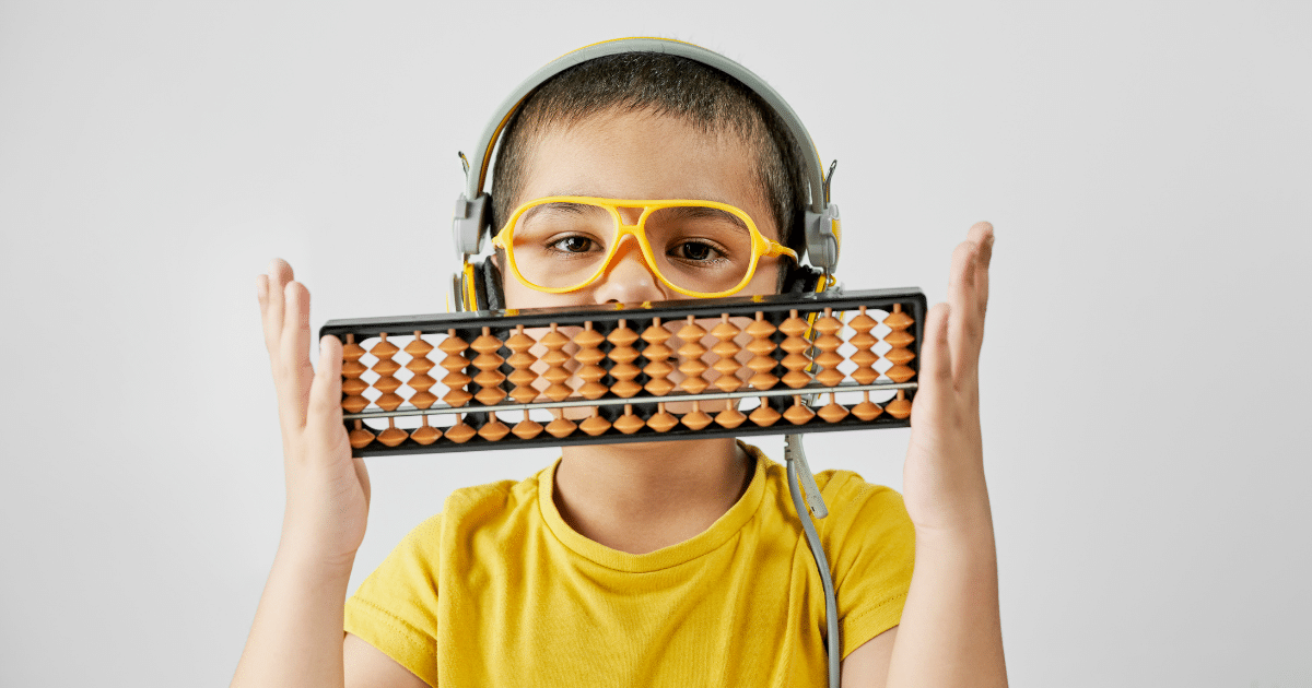 Child wearing headphones and holding an abacus